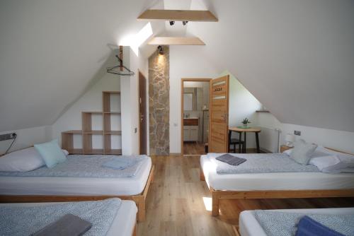 a room with three beds and a staircase at Ski House Szczyrk - Czyrna in Szczyrk