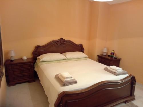 a bedroom with a large bed with two night stands at VILLA CORTESE in SantʼEufemia Lamezia