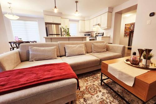 a living room with a couch and a table at Cozy 4 bedrooms home Milton in Milton