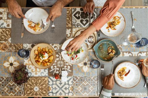 a group of people sitting at a table eating food at Terminus City Center Oujda in Oujda