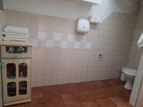 La salle de bains est pourvue de toilettes et d'un distributeur de serviettes. dans l'établissement Open House Timboré, à São Paulo