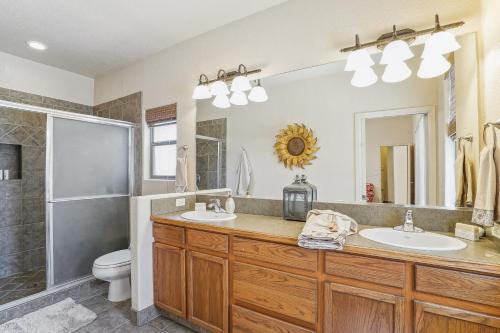 a bathroom with two sinks and a shower at Las Cruces Vacation Rental Near Trails and Golf! in Las Cruces