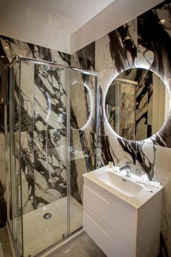 a bathroom with a sink and a mirror at Forever Luxury Rooms in Castellammare di Stabia