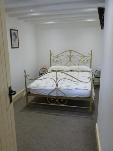 a bedroom with a bed with a metal frame at The Old Map Shop in Wigton