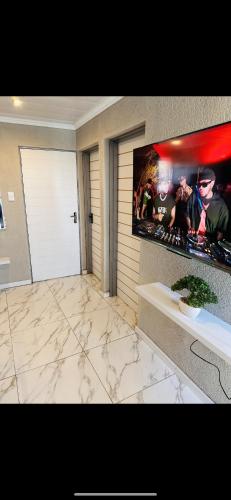 a living room with a large poster on the wall at The Pool_deck apartment in Lebowakgomo