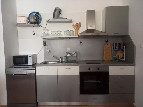 a small kitchen with a sink and a microwave at Sozopoli Hills, app B7 in Sozopol