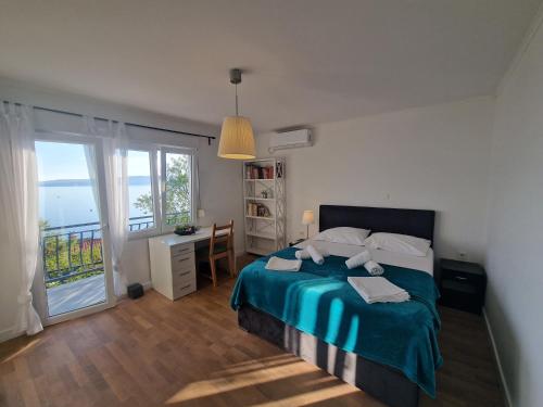 a bedroom with a bed with a view of the ocean at Villa Biondina in Senj