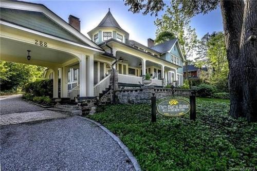 a large house with a sign in front of it at Black Walnut B&B Inn in Asheville