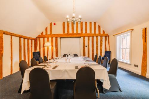 a conference room with a long table and chairs at Muthu Belstead Brook Hotel in Ipswich