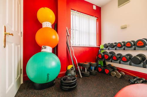a room with a gym with a bunch of balls and dumbles at Muthu Belstead Brook Hotel in Ipswich