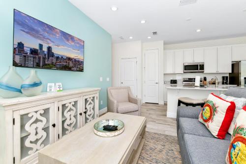 a living room with a couch and a table at Margaritaville Cottages Orlando with H2O Waterpark by Rentyl in Kissimmee