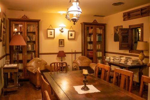 a dining room with a wooden table and chairs at YIT Vereda Real in Valencina de la Concepción