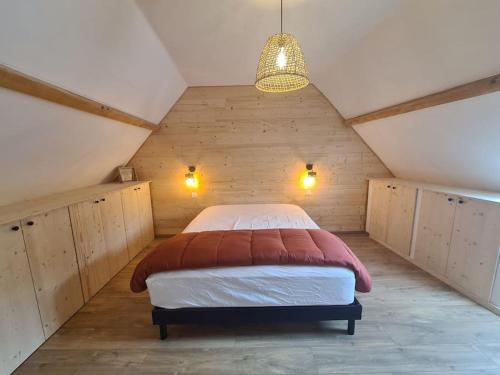 a bedroom with a large bed in a attic at Le cocon paisible in Asté