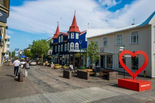 a red heart statue in the middle of a street at Saga Apartments Akureyri in Akureyri