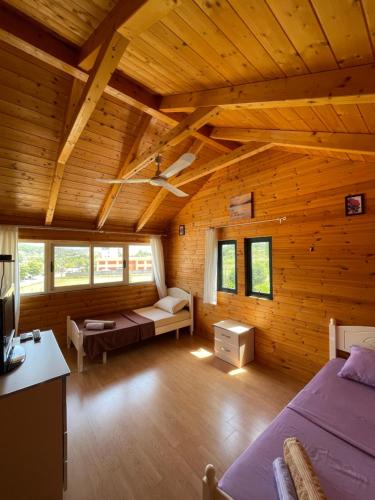 a room with two beds in a wooden cabin at Vila Livio - Guest house Rreshen Mirdite in Rrëshen