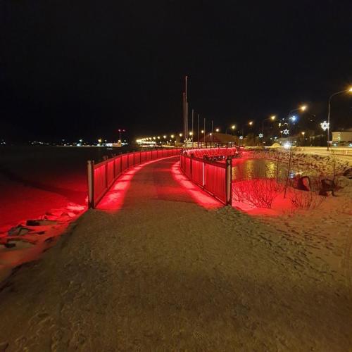 a red lighted path on the beach at night at Saga Apartments Akureyri in Akureyri