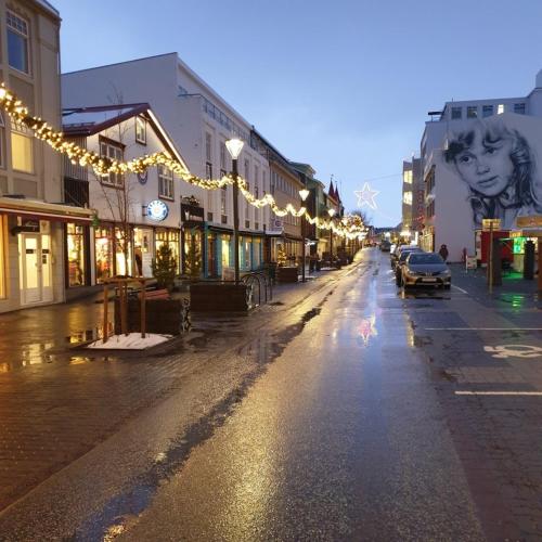 an empty city street with christmas lights on the buildings at Saga Apartments Akureyri in Akureyri