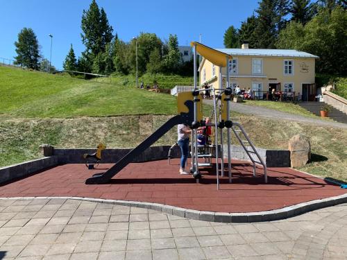 a child on a slide at a playground at Saga Apartments Akureyri in Akureyri
