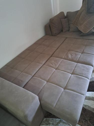 a large brown bed in a room with a couch at Ulcinj Apartments in Ulcinj
