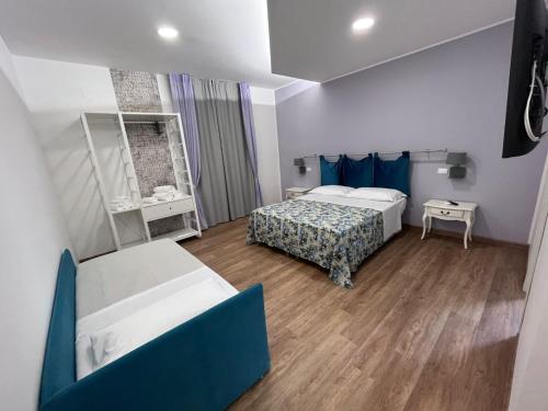 a small room with two beds and a table at La Casa di Matilde in Barcellona-Pozzo di Gotto