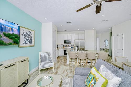 a living room with a couch and a table at Margaritaville Cottages Orlando with H2O Waterpark by Rentyl in Kissimmee