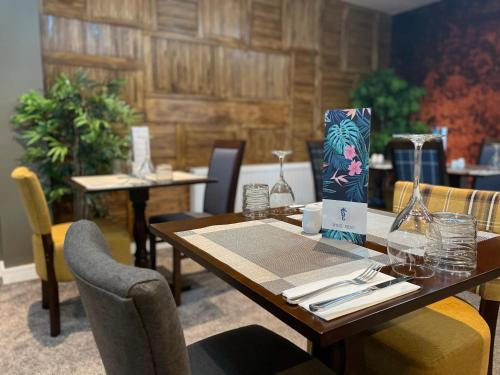 a table in a restaurant with two tables and chairs at The seahorse in Blythe
