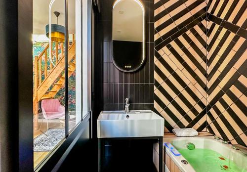 a bathroom with a sink and a bath tub at Flamant Rose in Annecy
