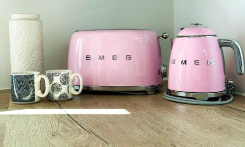 two hello kitty toasters and mugs on a table at Flamant Rose in Annecy