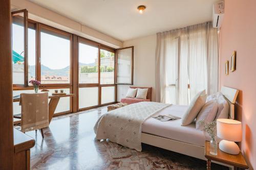 a bedroom with a large bed and a desk with a table at Piazza Cavour Lake View - by MyHomeInComo in Como