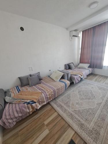 two beds are sitting in a room at Arel's Home in Prizren