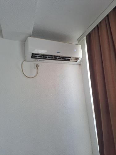 a air conditioner on the ceiling of a room at Arel's Home in Prizren