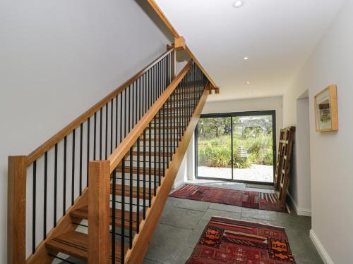 a staircase in a home with a large window at Paddock Barn in Chippenham