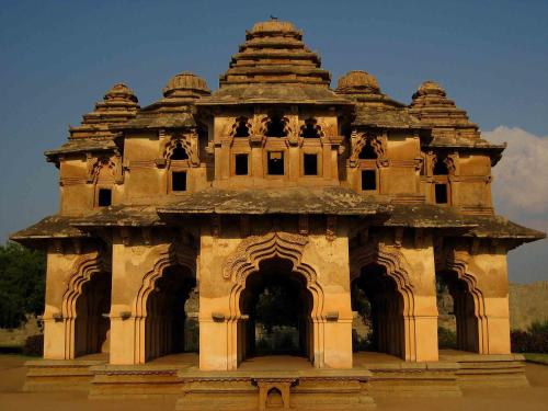 a large building with a tower with an entrance at Malligi,Hampi in Hospet
