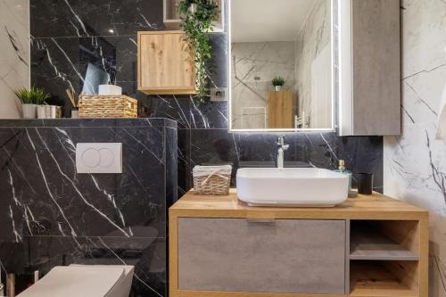 a bathroom with a sink and a mirror at Villa Bella Split - Podstrana in Podstrana
