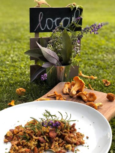 a plate of food on a table in the grass at Brunarica Macesen Smogavc in Zreče
