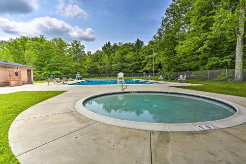 a swimming pool in the middle of a yard at Fire Pit and Grill Woodside Nest in Pocono Lake! in Pocono Lake