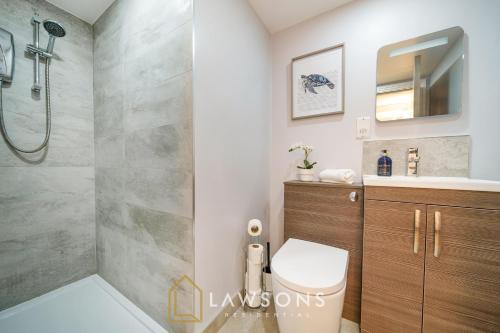 a bathroom with a shower and a toilet and a sink at Cosy Living by Lawsons in Windsor