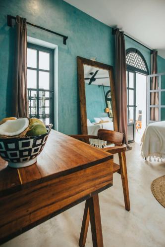 a room with a wooden table and a mirror at Yum Kaax Boutique Villa in Tulum