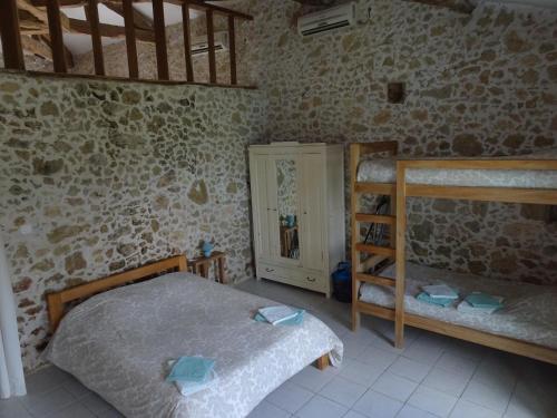 a bedroom with two beds and a bunk bed at GersGites in Justian