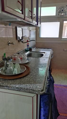 a kitchen counter with a sink and a plate on it at المعمورة الشاطىء in Alexandria