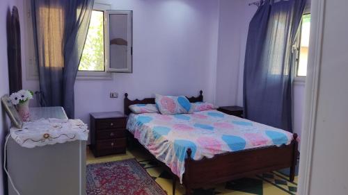 a bedroom with a bed and a table and a window at المعمورة الشاطىء in Alexandria