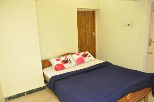 una piccola camera da letto con un letto con due cuscini di Sagar homestay a Thanjāvūr