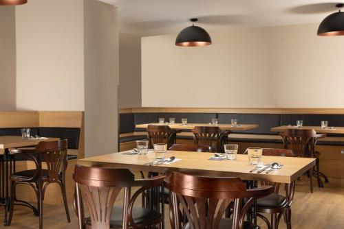 a dining room with wooden tables and chairs at Pivovar Rožmberk in Rožmberk nad Vltavou