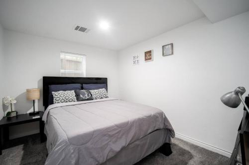 a bedroom with a bed and a desk with a lamp at Downtown Houston Oasis - Walk to TSU or UH in Houston