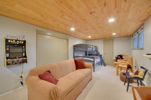 a living room with a couch and a wooden ceiling at Beautiful Chetek Home with Prairie Lake Access! in Chetek