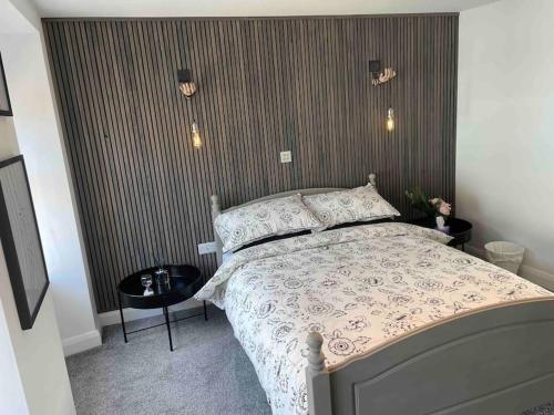 a bedroom with a bed with a white comforter at ROOMZ TOWNHOUSE NO 20 in Portaferry