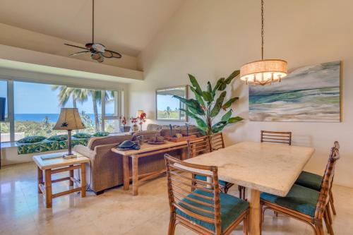 a living room with a table and a couch at Palms at Wailea in Wailea