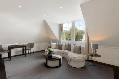 a living room with a couch and a table at Wonderful Knightsbridge Apartment by Harrods in London