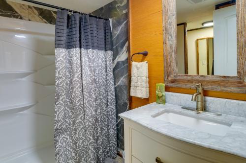 a bathroom with a shower curtain and a sink at New Concord Vacation Rental Near Kentucky Lake in New Concord