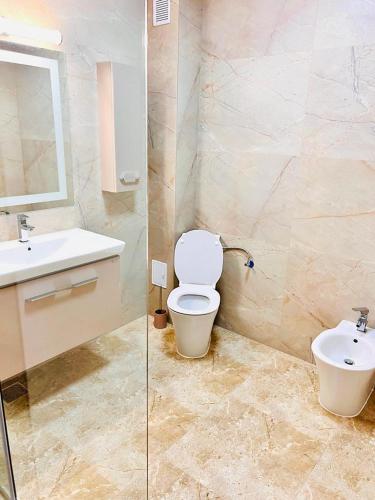a bathroom with a toilet and a sink at KIR House On The Beach in Eforie Nord